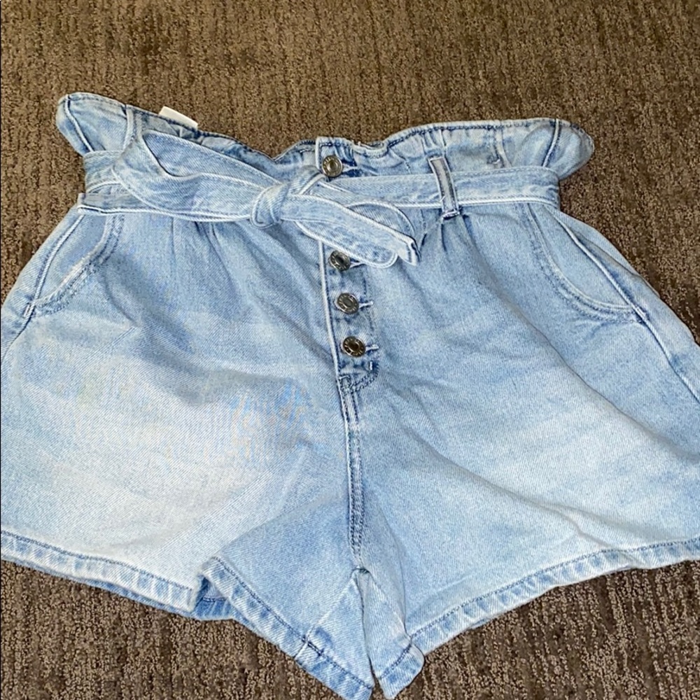 Blue high waisted jean shorts with a tie